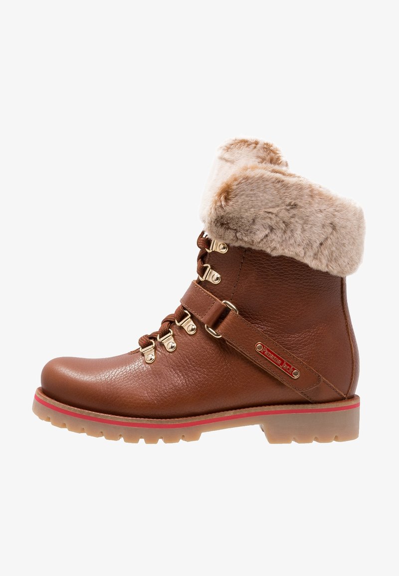 Brown leather boot with a faux fur cuff, gold hardware, and a red accent on the sole. Features lace-up design and side strap detail.