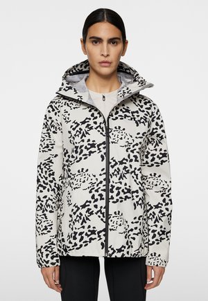 Damen wasserdichte Jacke, leicht, weiß mit schwarzem abstraktem Leopardenmuster, mit durchgehendem Reißverschluss, Kapuze, elastischen Bündchen und Saum. Glatte Textur.