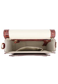 Top view of an open rectangular beige handbag with brown crocodile pattern trim and internal pockets, including a zippered compartment.