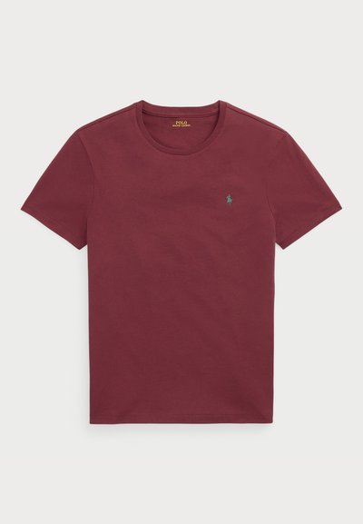 T-shirt de algodão bordeaux com decote redondo, mangas curtas e um pequeno logotipo verde no lado esquerdo do peito. Textura suave, ajuste padrão.