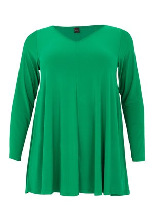 Tunique verte à col en V avec manches longues, en tissu doux, présentant une coupe ample qui s'évase à partir de la taille et un détail de couture centrale.