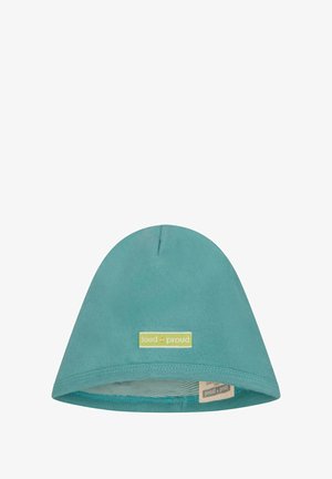 Beanie in cotone color teal con una consistenza morbida, cima arrotondata e un'etichetta verde con "loud + proud". All'interno presenta una fodera a righe.