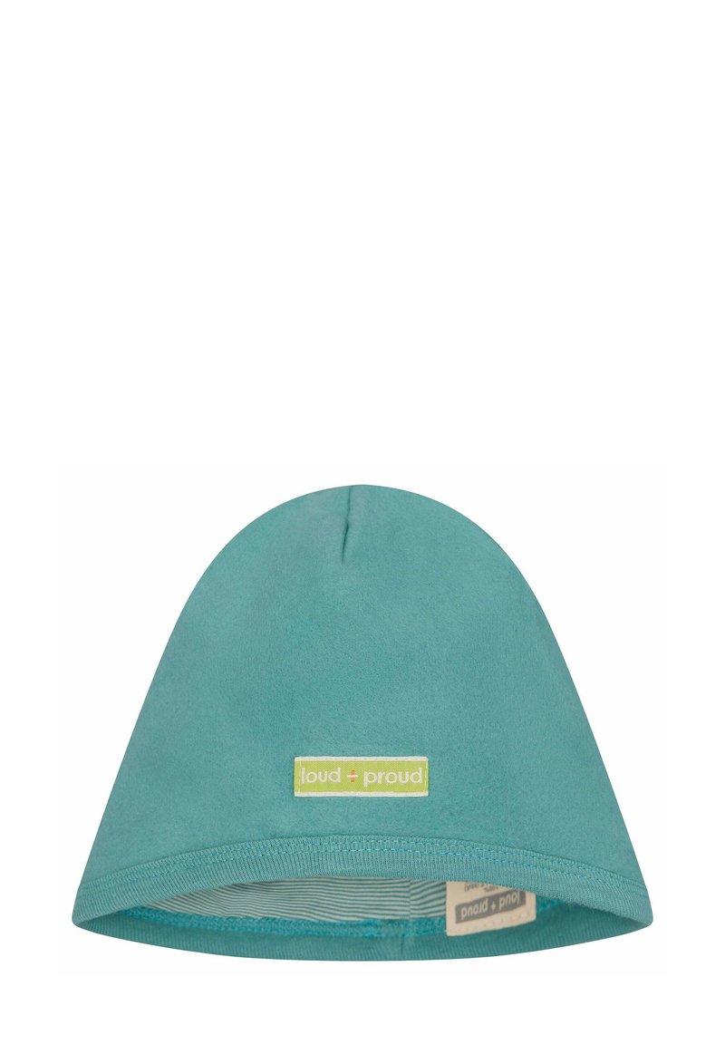 Beanie in cotone color teal con una consistenza morbida, cima arrotondata e un'etichetta verde con "loud + proud". All'interno presenta una fodera a righe.