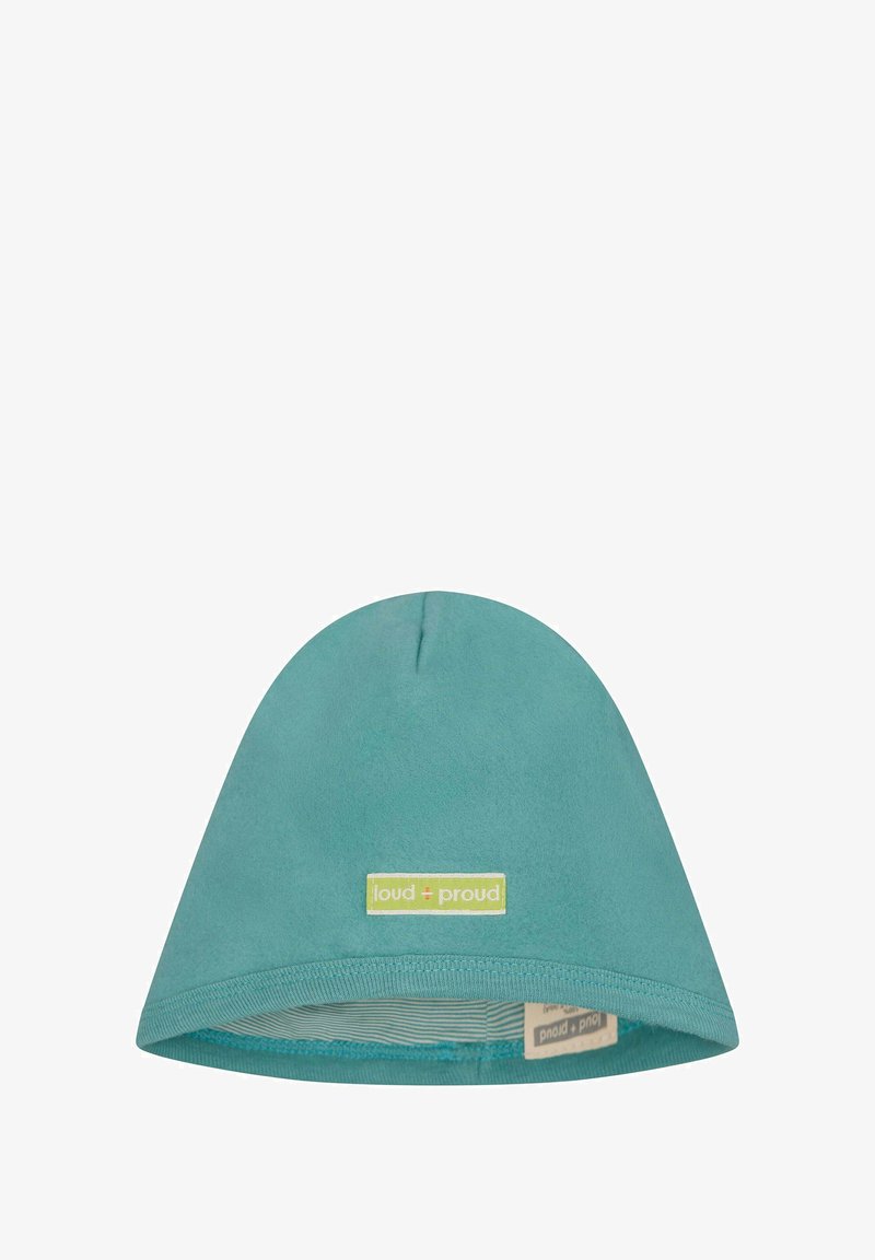 Beanie in cotone color teal con una consistenza morbida, cima arrotondata e un'etichetta verde con "loud + proud". All'interno presenta una fodera a righe.