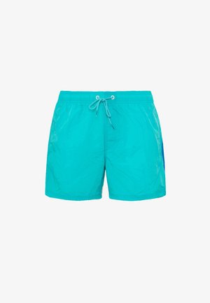 Turquoise zwembroek met een elastieke tailleband, koordsluiting en een zijpaneel in een donkerder blauw. Gladde textuur en relaxte pasvorm.