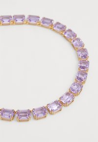Purple rectangular gemstones set in gold-toned metal, forming a smooth, continuous chain necklace with a glossy finish.