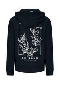 Felpa navy con disegno floreale bianco all'interno di un riquadro e il testo "SII AUDACE" e "RETOUR DAL '89" sul retro.
