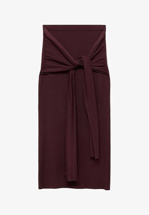 Burgundy dress featuring a knotted tie detail at the waist, made from a smooth, stretchy fabric. Fitted silhouette with a straight length.