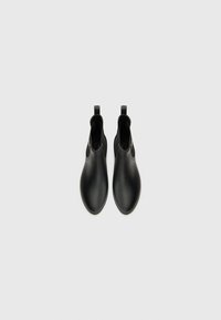 Black ankle boots made from smooth material, featuring a sleek design, rounded toe, and pull-tabs for easy wear.