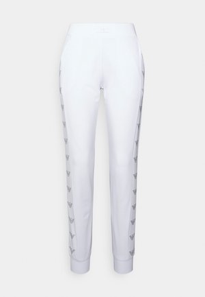 Witte taps toelopende joggerbroek met elastische taille en zwarte merklogo's langs beide zijnaden.