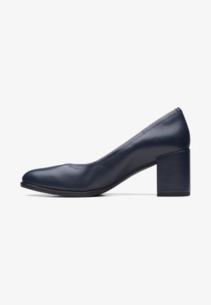Escarpin pour femmes en cuir bleu marine avec un bout arrondi et un talon épais, bas et carré, présenté de profil sur un fond blanc.