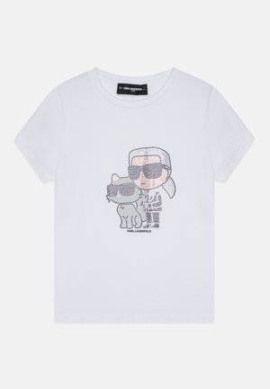 T-shirt en coton blanc avec un graphisme en strass représentant une silhouette portant des lunettes de soleil avec un chat, tous deux contournés en noir, avec un col rond.