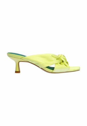 Yellow satin mules with a knotted upper, open toe, and a 5 cm sculpted heel. Interior features a contrasting teal insole.