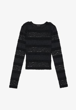Black long-sleeve sweater with a textured, striped lace design. Features ruffled accents on the edges and a rounded neckline.