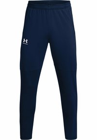 Marina blå träningsbyxor tillverkade av ett slätt, stretchigt tyg. Har en elastisk midja och en vit logotyp p å vänster lår.