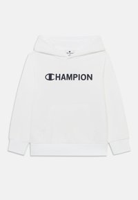 Sudadera blanca con capucha que incluye un bolsillo frontal, puños y dobladillo acanalados. Logo negro de "CHAMPION" impreso en el pecho. Acabado textil suave.
