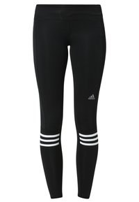 Svarta atletiska leggings gjorda av sträckbart material, med hög midja och tre vita ränder på de nedersta benen. Adidas-logotyp ingår.