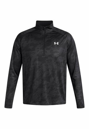 Black long-sleeve pullover with a quarter zip, featuring a subtle camo pattern. Made of lightweight, moisture-wicking fabric. Under Armour logo on chest.