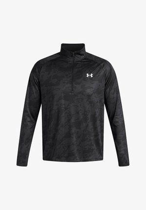 Sort langærmet pullover med kvart lynlås, der har et subtilt camouflagemønster. Fremstillet af letvægts, fugttransporterende stof. Under Armour-logo på brystet.