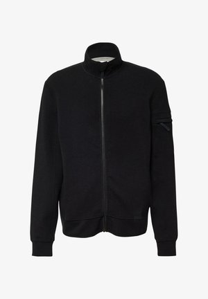 Giacca nera con zip in tessuto misto cotone, caratterizzata da colletto alto, tasche laterali e una tasca con zip sulla parte superiore della manica. Tessuto dalla texture liscia.