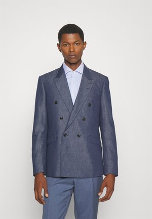 Marineblå dobbeltbrystet blazer i let stof med strukturerede revers, seks sorte knapper og to frontlommer, parret med en stribet skjorte.