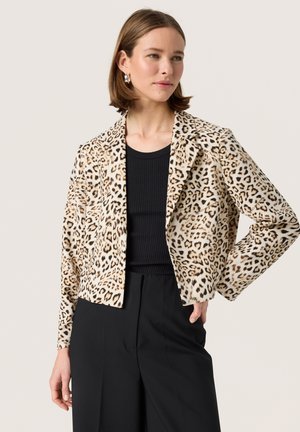Blazer mit Leopardenmuster in tan und schwarzen Tönen, mit taillierter Passform, Reverskragen, langen Ärmeln und glatter Textur. Kombiniert mit einem schwarzen Oberteil.