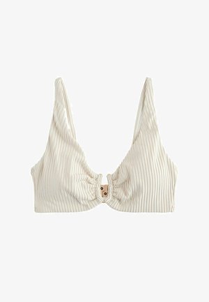 Bralette en tissu côtelé blanc avec col en V profond, fines bretelles et fermeture à clip à l'avant.