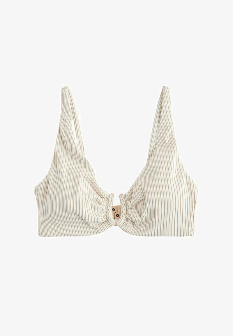 Bralette en tissu côtelé blanc avec col en V profond, fines bretelles et fermeture à clip à l'avant.