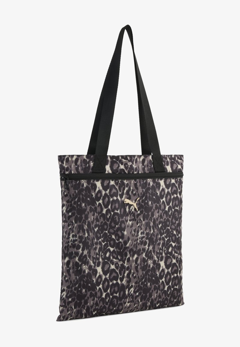 Sac fourre-tout avec imprimé léopard noir et gris, bretelles noires, poche avant zippée et petit logo Puma doré sur le devant.