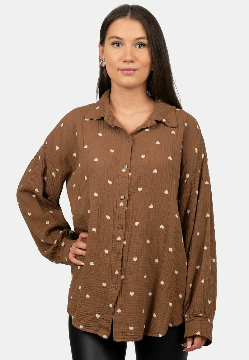 Brown long-sleeve shirt in textured fabric with white heart-shaped patterns, featuring a button-up front and a classic collar.