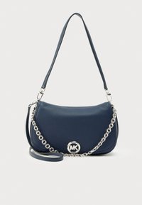 Navy leather handbag with a structured design, featuring a chain accent strap and a circular MK logo on the front. Smooth texture.