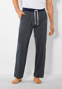 Heren grijze loungebroek met een marineblauwe elastische tailleband, witte trekkoord en zijzakken. Zachte, losse stof biedt comfort.