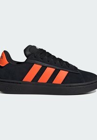 Sneaker in suede nero con tre strisce arancioni, punta tonda, lacci neri e suola in gomma. Logo sul tallone e sulla linguetta.