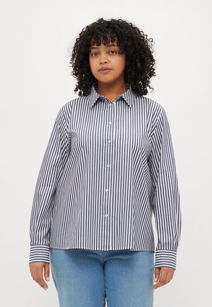 Button-up shirt in navy and white vertical stripes, made of lightweight fabric. Features a pointed collar and long sleeves with contrasting cuffs.