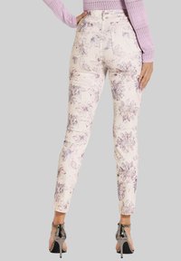 Helle, blühend gemusterte Skinny-Jeans mit hoher Taille, Vorder- und Gesäßtaschen sowie einer taillierten Silhouette.