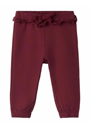 Bordowe legginsy z elastycznym paskiem w talii, falbaniastym wykończeniem na górze i marszczonymi mankietami przy kostkach, wykonane z miękkiego, elastycznego materiału.