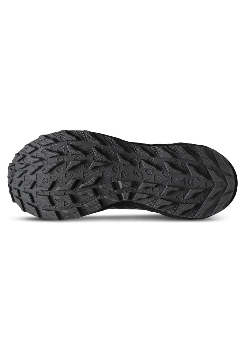 Suela de zapato de goma negra con patrones de banda de rodadura profundos y agresivos, con bordes y hoyuelos para ofrecer tracción en diversas superficies.