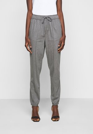 Pantalones jogger ajustados grises con cintura elástica y cordón. Presenta dobladillos ajustados y una tela suave y texturizada.