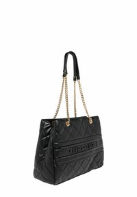 Black quilted handbag with a structured shape, featuring gold chain straps and a prominent logo on the front. Smooth texture and spacious design.