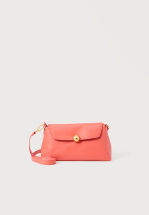 Coral pink leather clutch bag with a gold round clasp and a detachable wrist strap on a plain light background.