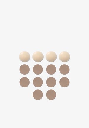 Set di cuscinetti circolari in silicone: tre sfere color crema e otto cerchi color beige, superficie liscia, dimensioni uniformi, disposti in righe.