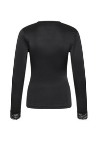 Haut noir à manches longues pour femme, vu de dos, avec bordure en dentelle aux poignets, coupe ajustée et col rond.