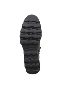 Czarna gumowa podeszwa z teksturowanym wzorem bieżnika, uzupełniona zielonym płótnem u góry i z zamkiem błyskawicznym z boku. Rozmiar 38 zaznaczony wewnątrz.