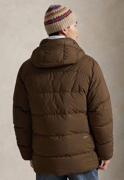 Brown puffer jacket with a hood, featuring a quilted design and a soft texture. Paired with a patterned knit beanie, showcasing vibrant colors.