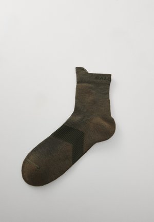 Brown ankle sock featuring a textured, geometric design with a ribbed cuff. Material is soft, blended fabric with a varying color pattern.