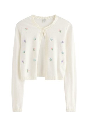 Valkoinen lyhyt neuletakki, jossa on pitkät hihat, pyöreä kaula-aukko, yksittäinen napitus ja edessä pienet kirjailut pastellivärisinä kukkina.