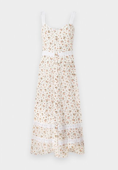 Φλοράλ μίντι φόρεμα σε κρέμα απόχρωση με ρυθμιζόμενες τιράντες, κουμπιά στο μπροστινό μέρος και λευκή δαντελένια λεπτομέρεια στη μέση και στο τελείωμα. Διακοσμείται με μικρά πορτοκαλί και πράσινα λουλούδια.