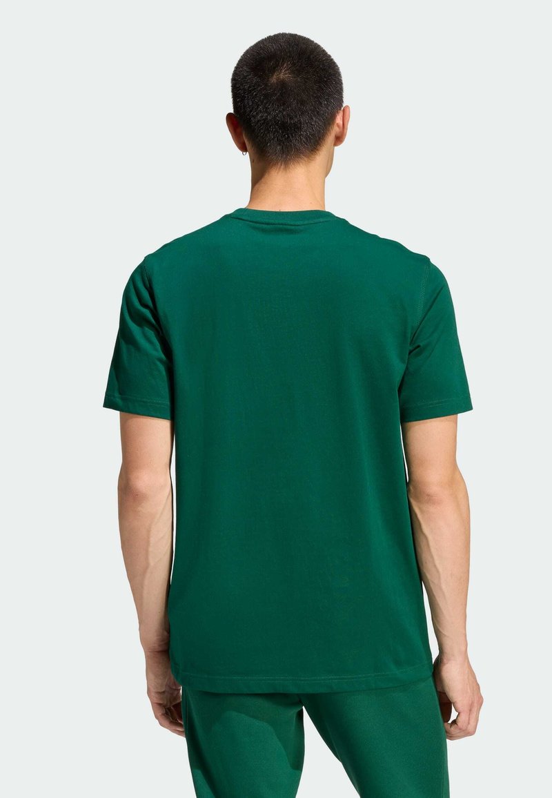 Zielony t-shirt z krótkim rękawem, z okrągłym dekoltem, gładką fakturą, luźnym krojem i przeszyciami przy kołnierzu oraz na dole.