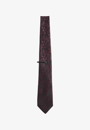 Burgundy silk tie with a tonal floral pattern, featuring a pointed tip and a black tie clip for secure fastening. Textured finish.