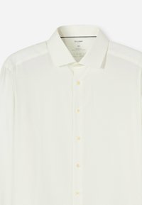 Witte overhemd met moderne pasvorm, lange mouwen en een spreadkraag. Heeft een subtiele textuur en lichtgekleurde knopen. Maat 40.